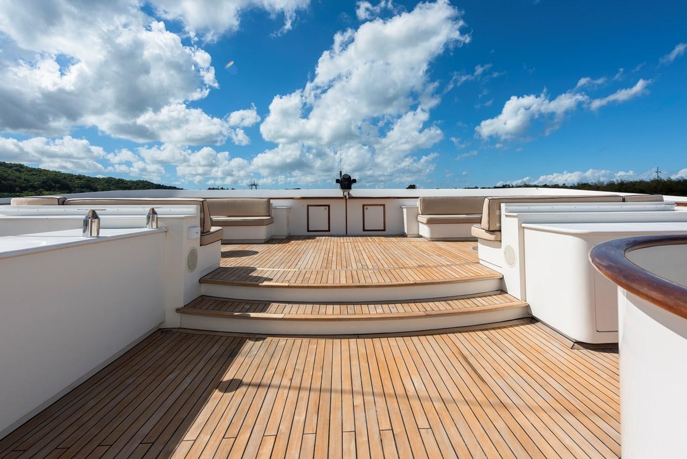 a wooden deck with a large pool aboard BIG ARON Yacht for Sale