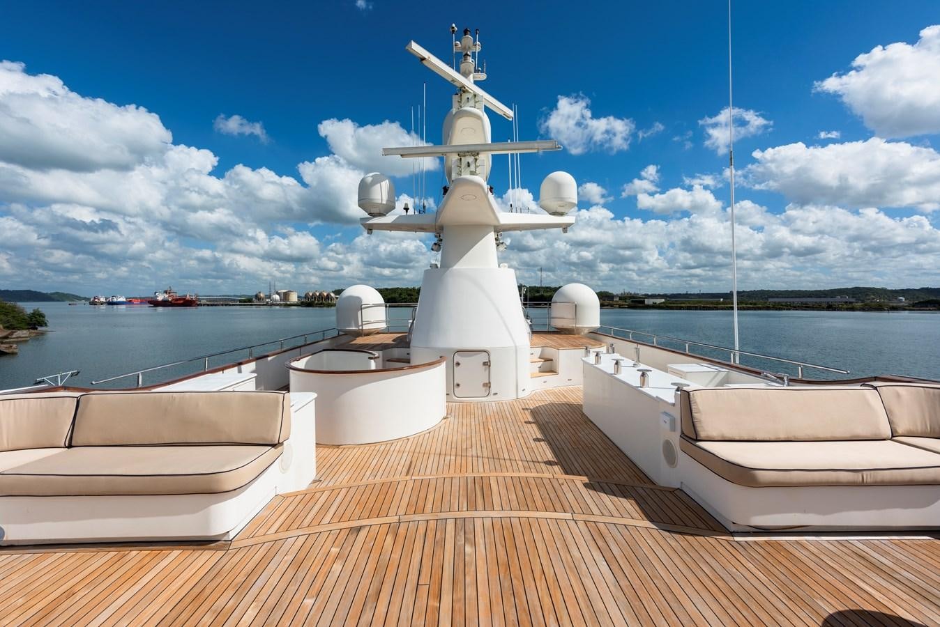 a deck with a deck and a large ship in the water aboard BIG ARON Yacht for Sale