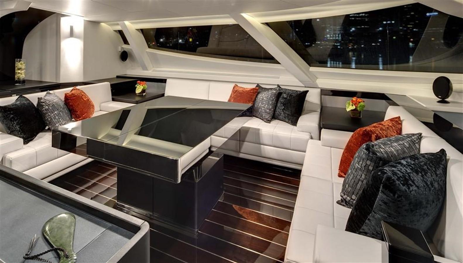 a room with a bed and a table aboard BLISS Yacht for Charter
