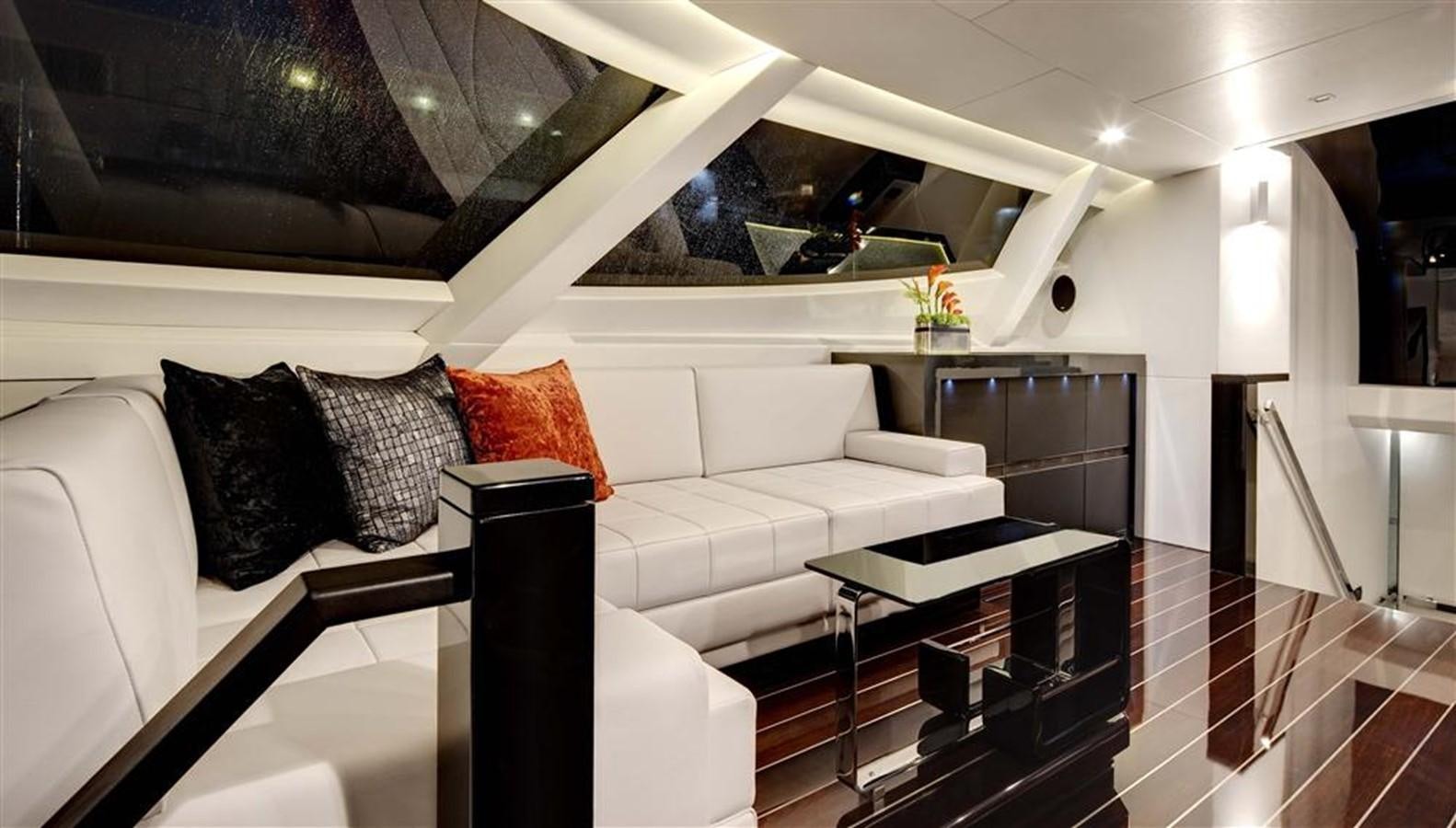 a living room with a white couch aboard BLISS Yacht for Charter