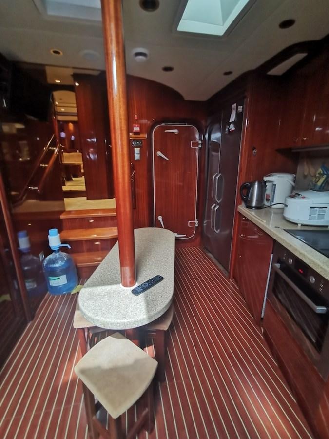 a kitchen with wooden cabinets aboard ALBINA Yacht for Sale