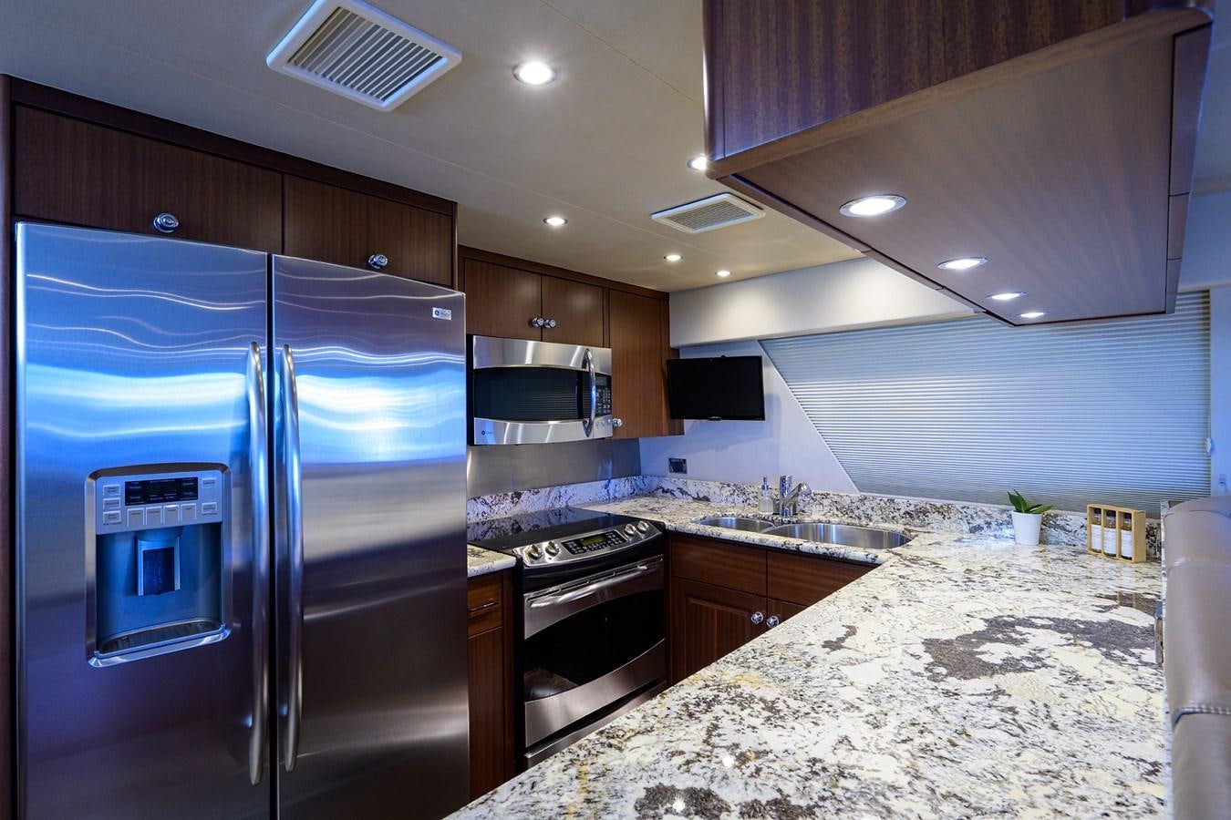 a kitchen with a stainless steel refrigerator aboard ROBINSON CRUSOE Yacht for Sale