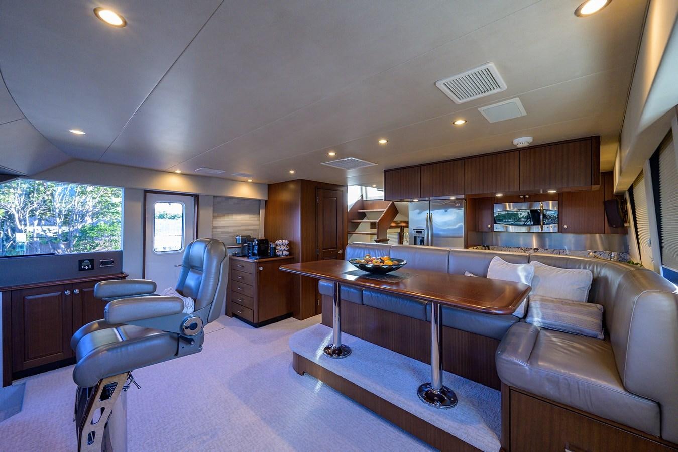 a living room with a table and chairs aboard ROBINSON CRUSOE Yacht for Sale