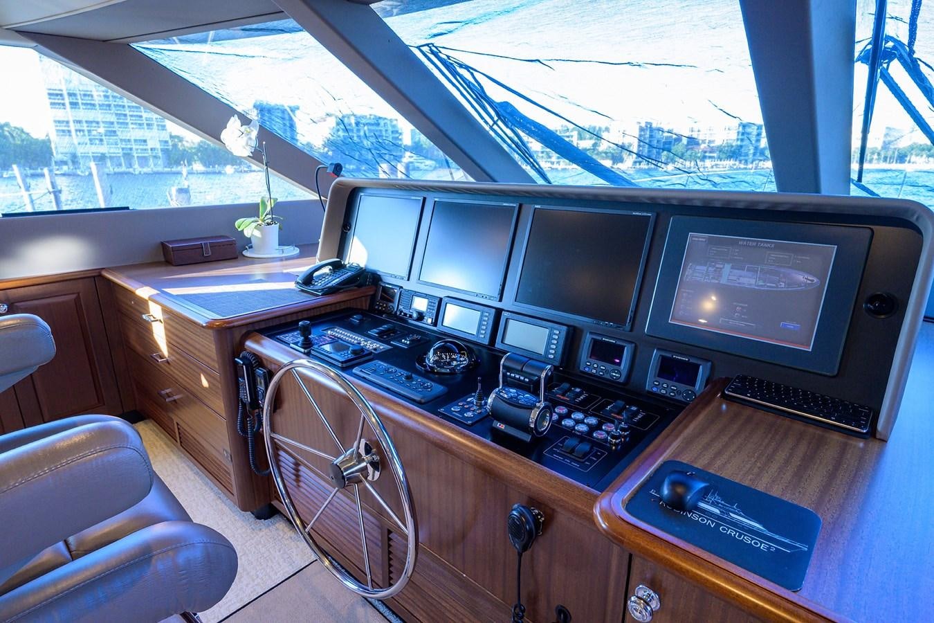 a desk with computers and monitors aboard ROBINSON CRUSOE Yacht for Sale