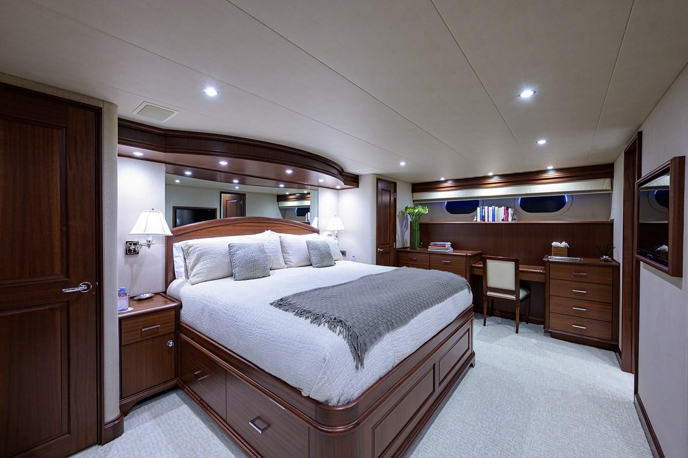 a bedroom with a bed and desk aboard ROBINSON CRUSOE Yacht for Sale