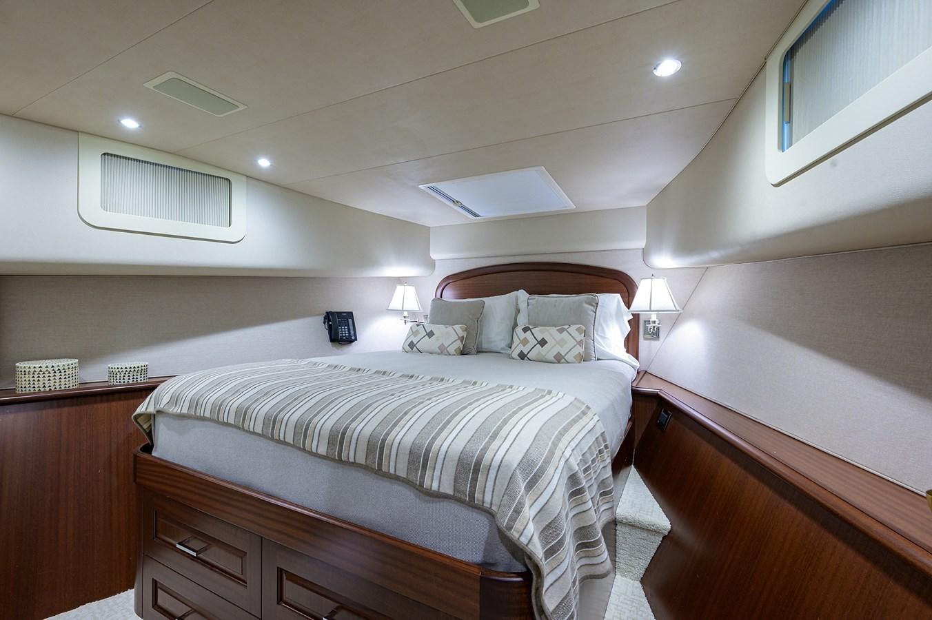 a bedroom with a bed and a desk aboard ROBINSON CRUSOE Yacht for Sale