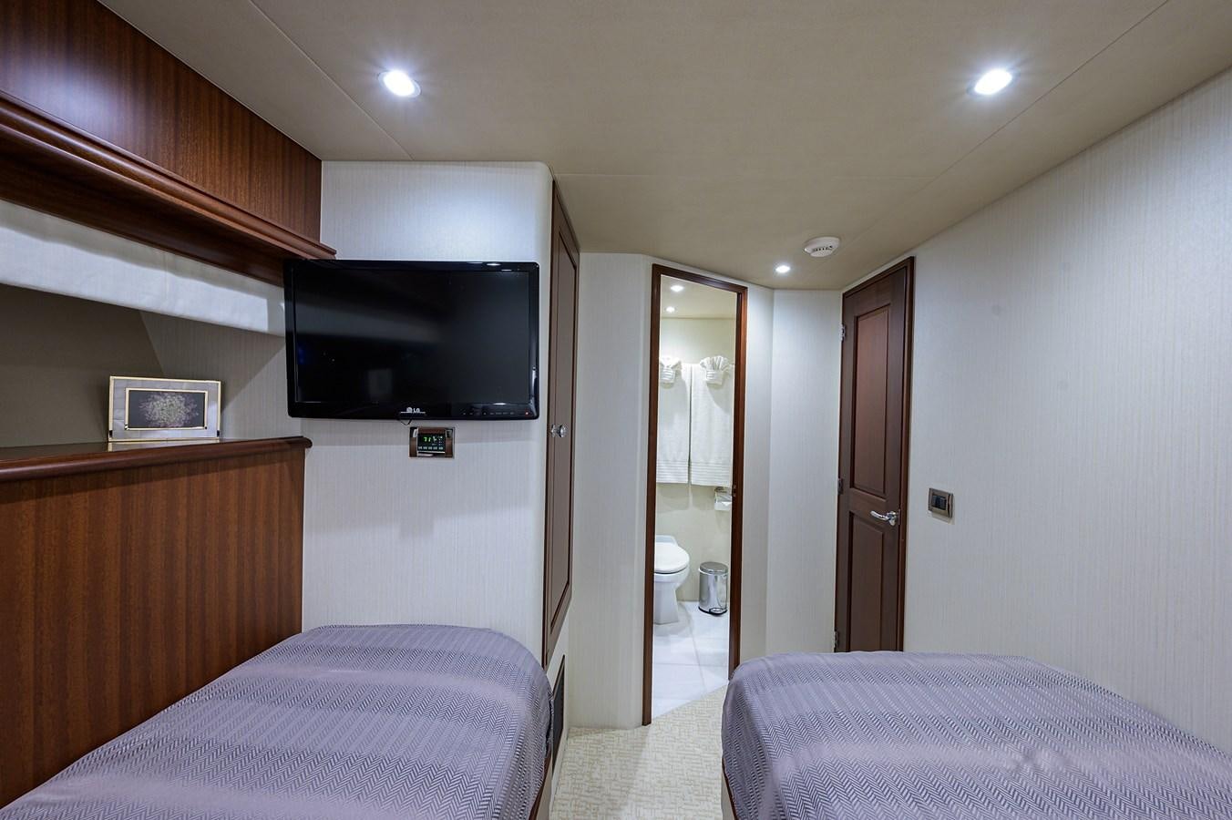 a bedroom with a bed and a television aboard ROBINSON CRUSOE Yacht for Sale