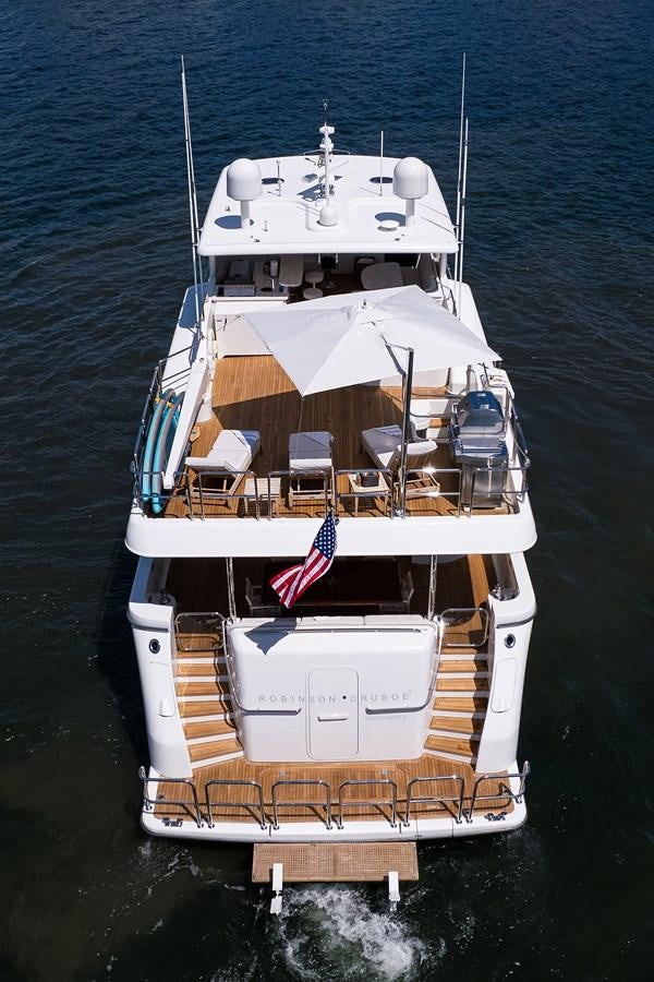 a boat with a flag on it aboard ROBINSON CRUSOE Yacht for Sale