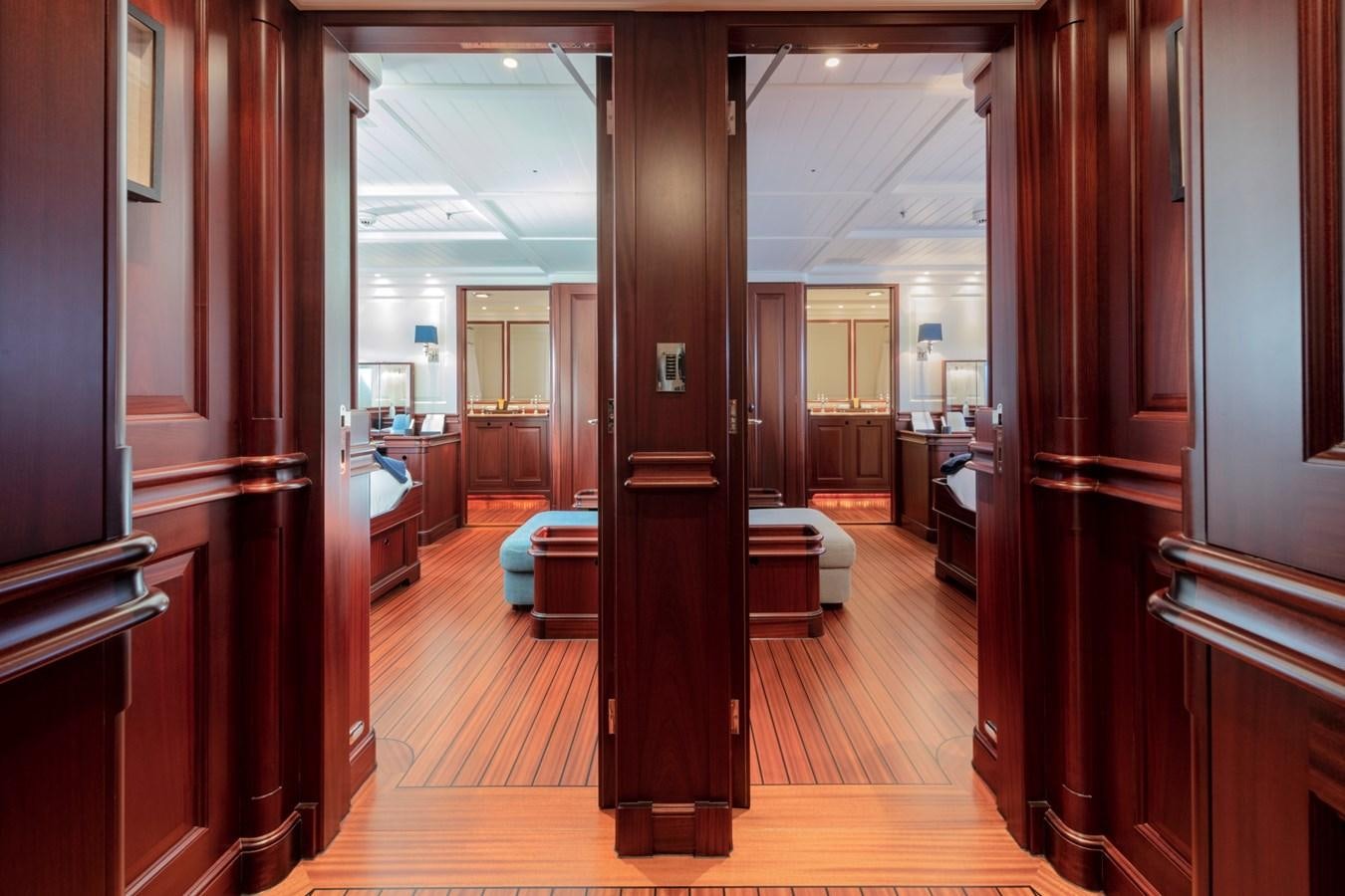 a room with a wood floor and a wood door aboard AWATEA Yacht for Sale