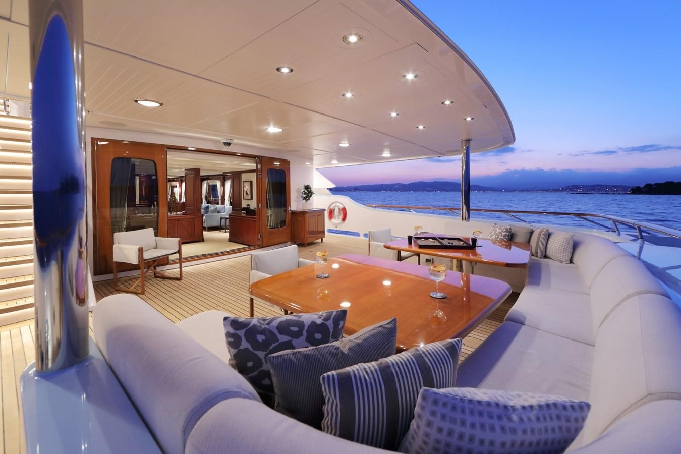 a living room with a large balcony aboard AWATEA Yacht for Sale
