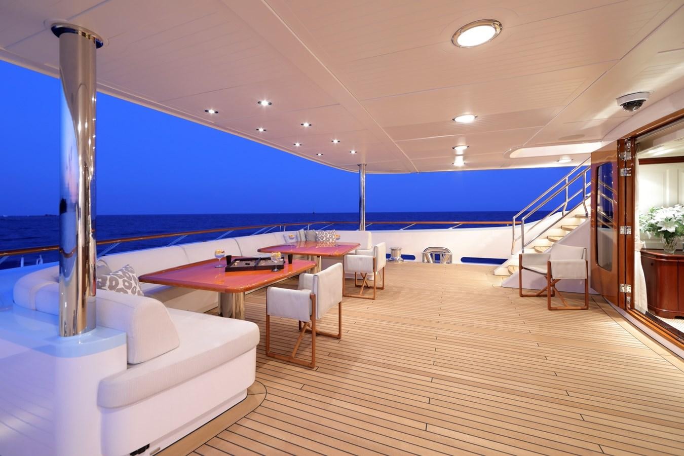 a room with a pool and a table and chairs aboard AWATEA Yacht for Sale