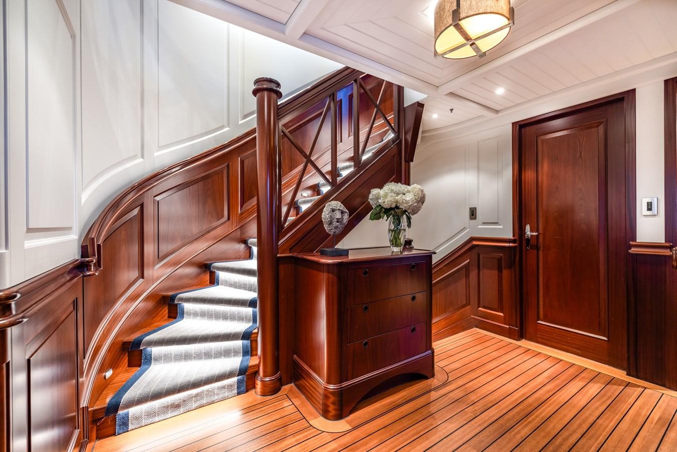 a wooden staircase in a house aboard AWATEA Yacht for Sale