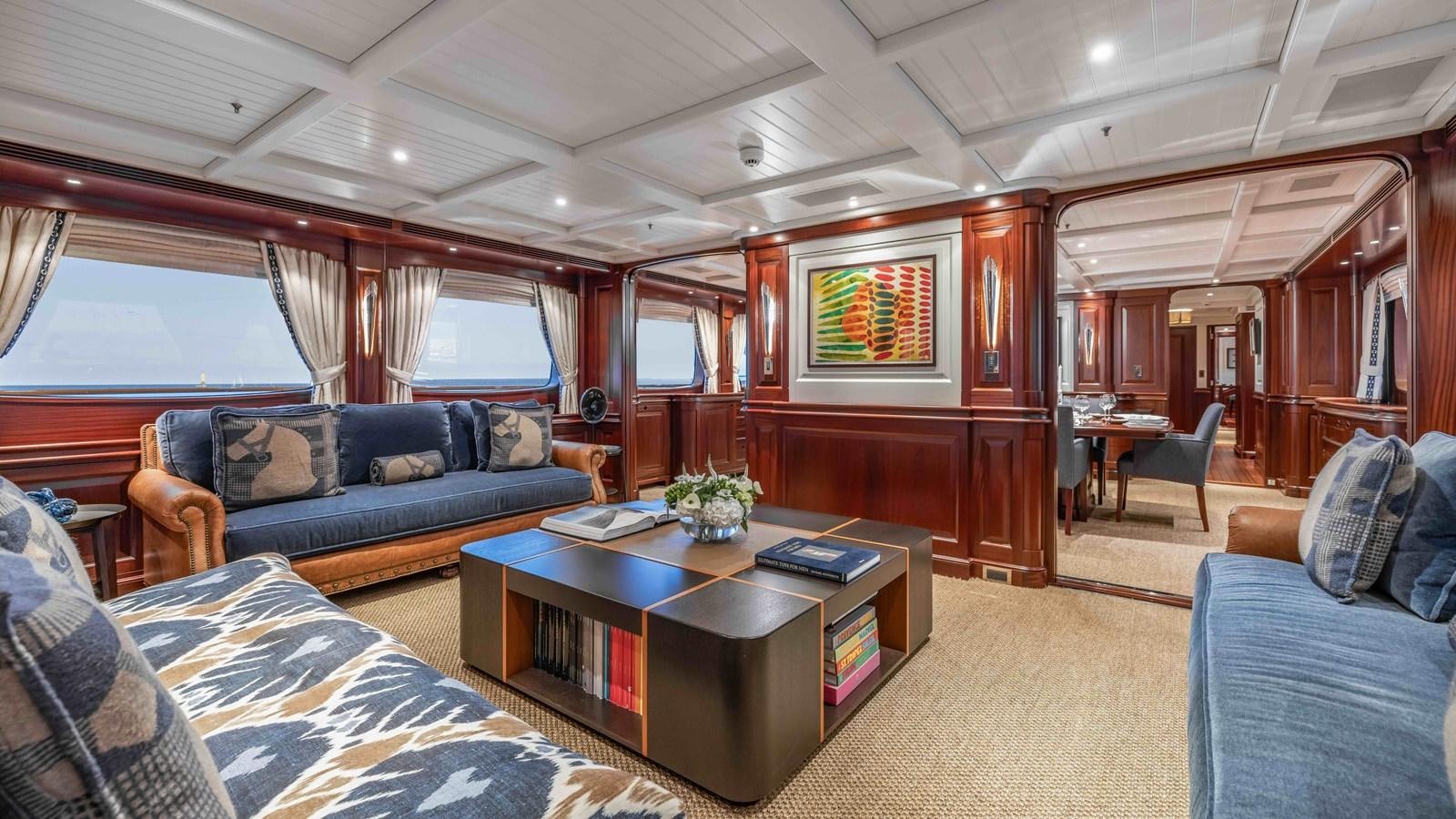 a living room with a couch and a coffee table aboard AWATEA Yacht for Sale