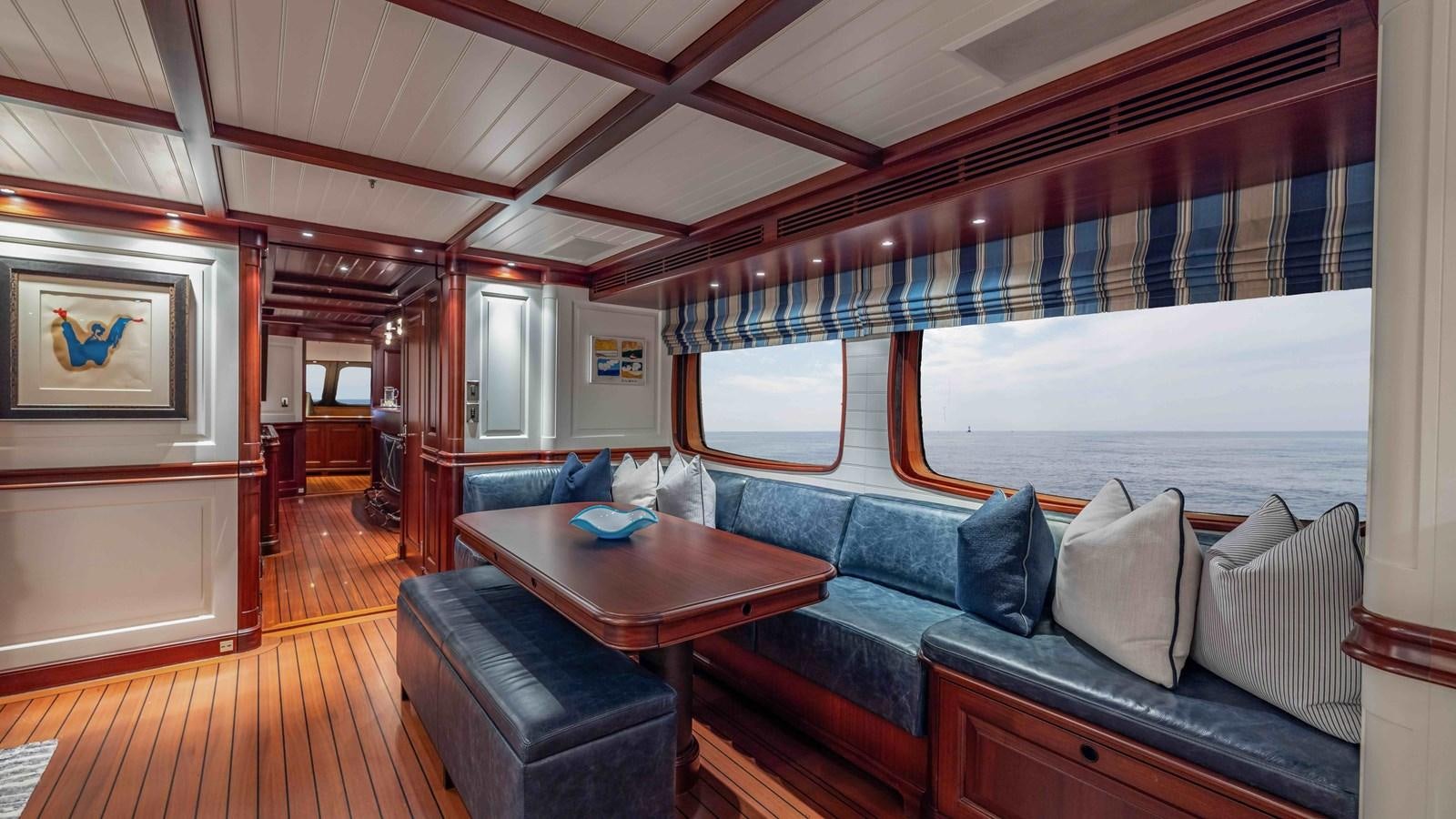a living room with a couch and a table aboard AWATEA Yacht for Sale