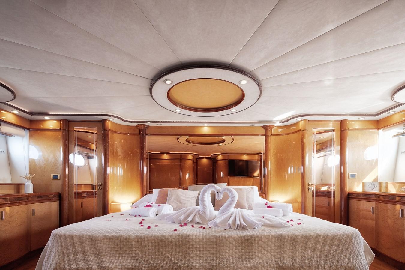 a bed with white sheets aboard NEPHENTA Yacht for Sale