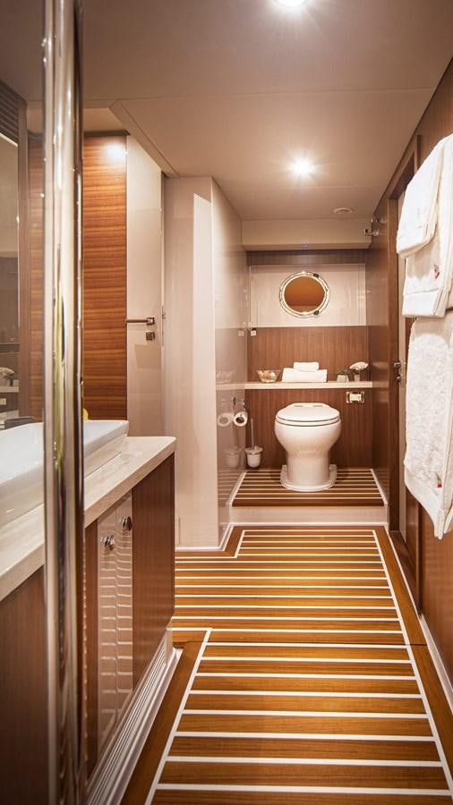 a bathroom with a toilet and a sink aboard BELIZE 66 DAYBRIDGE Yacht for Sale