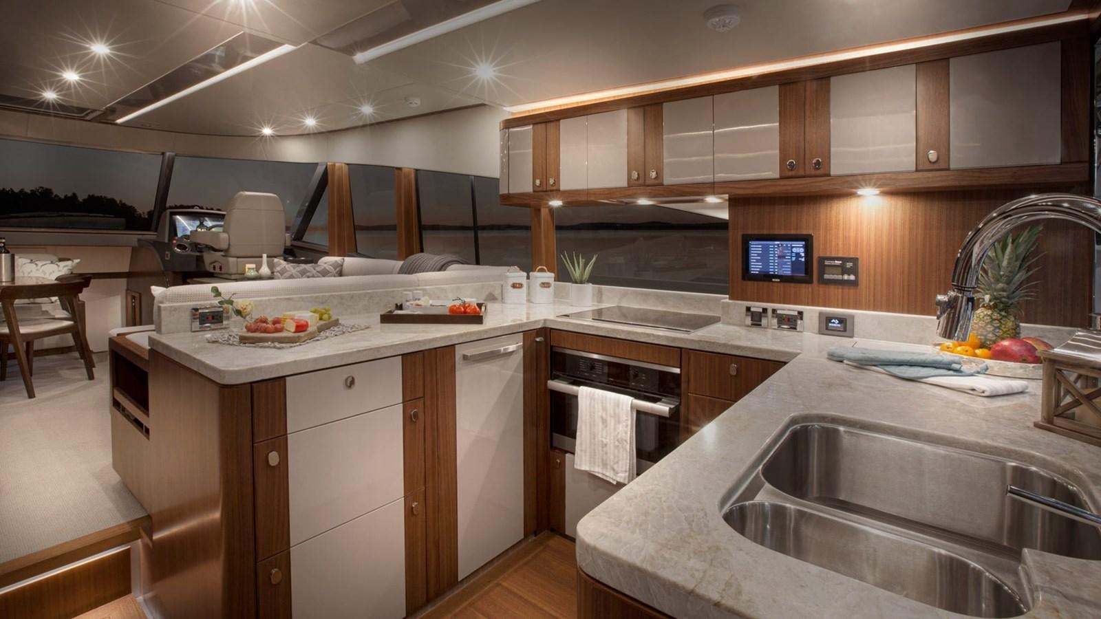 a kitchen with a large island aboard BELIZE 66 DAYBRIDGE Yacht for Sale