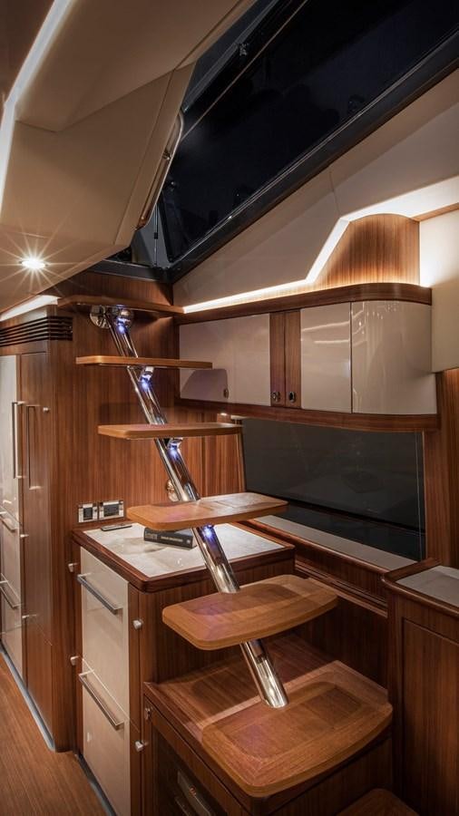 a wooden cabinet with a shelf aboard BELIZE 66 DAYBRIDGE Yacht for Sale