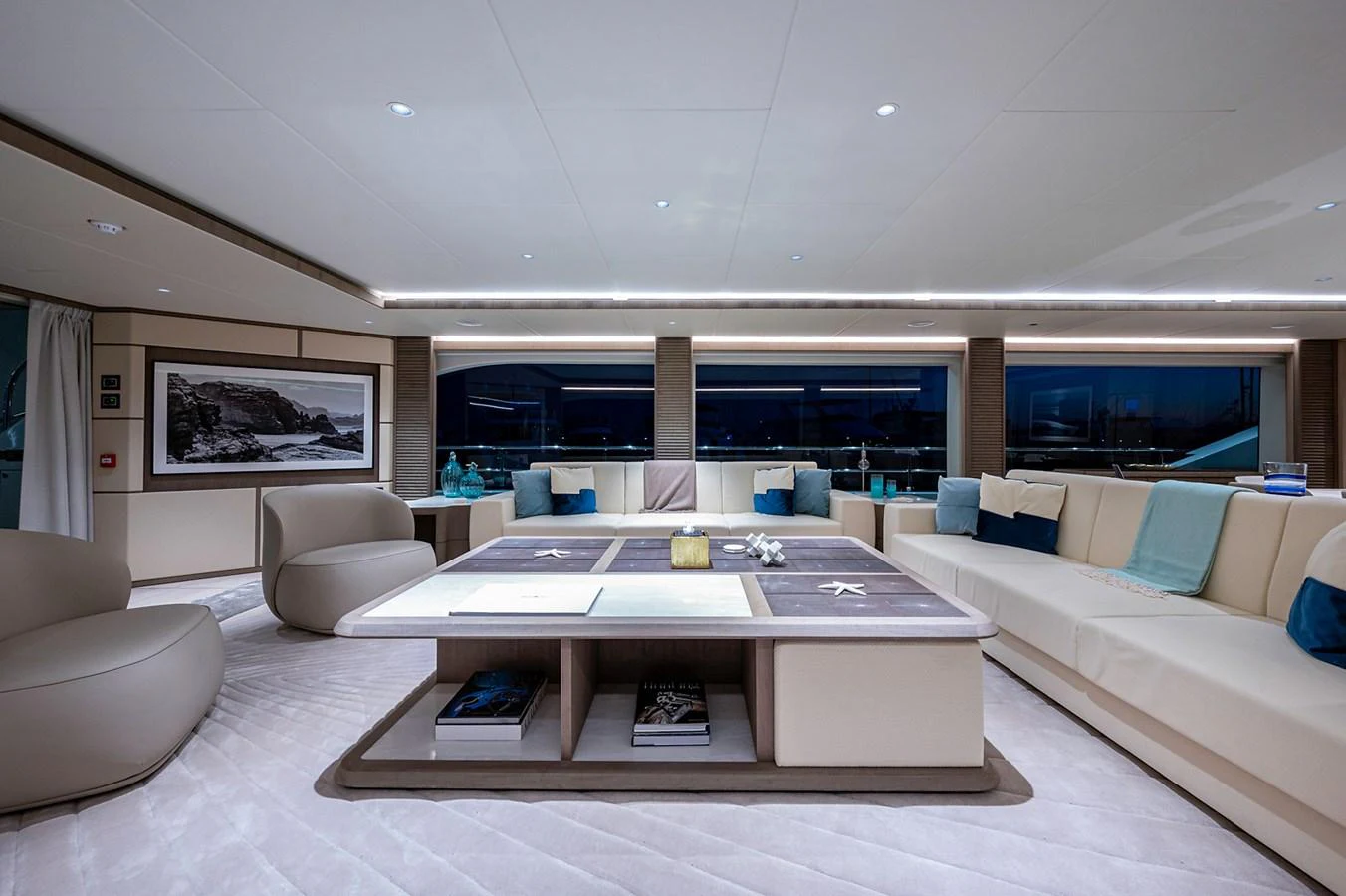 a modern living room with a large open floor plan aboard CHECKED OUT Yacht for Sale