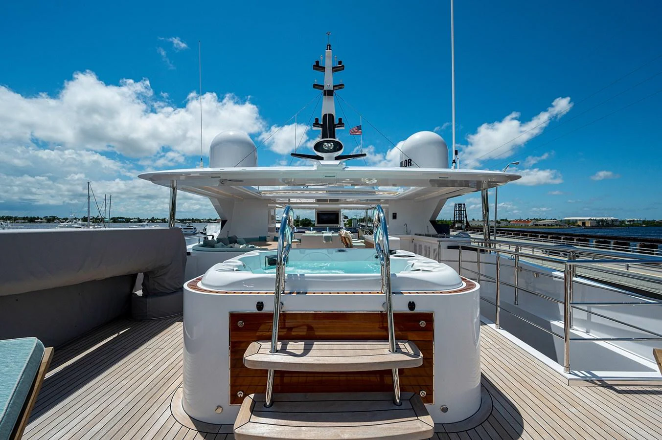 a white boat on a dock aboard CHECKED OUT Yacht for Sale