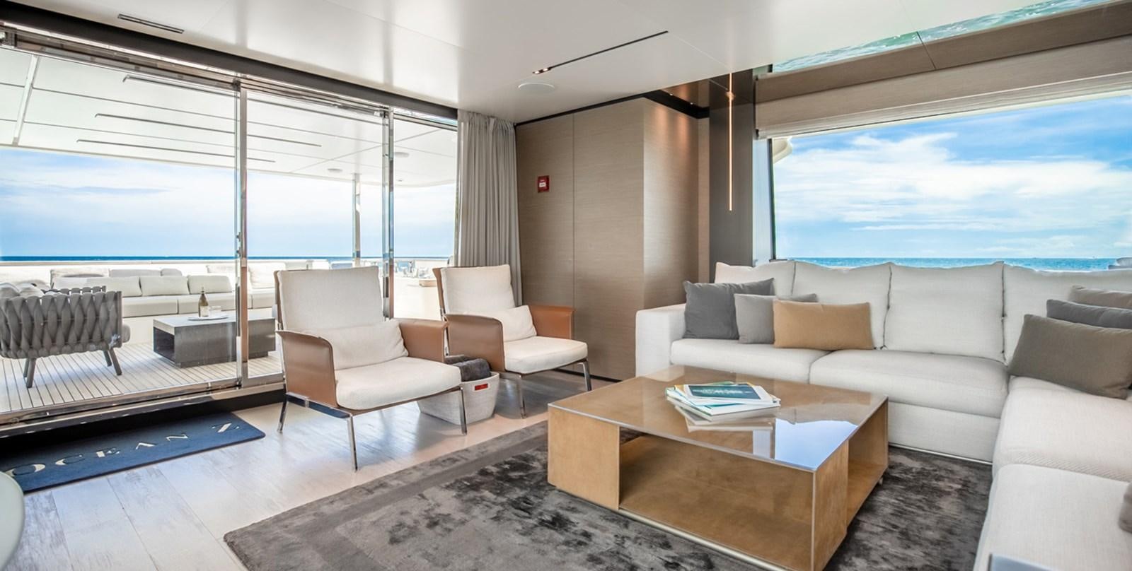 a living room with a large window aboard OCEAN Z Yacht for Sale