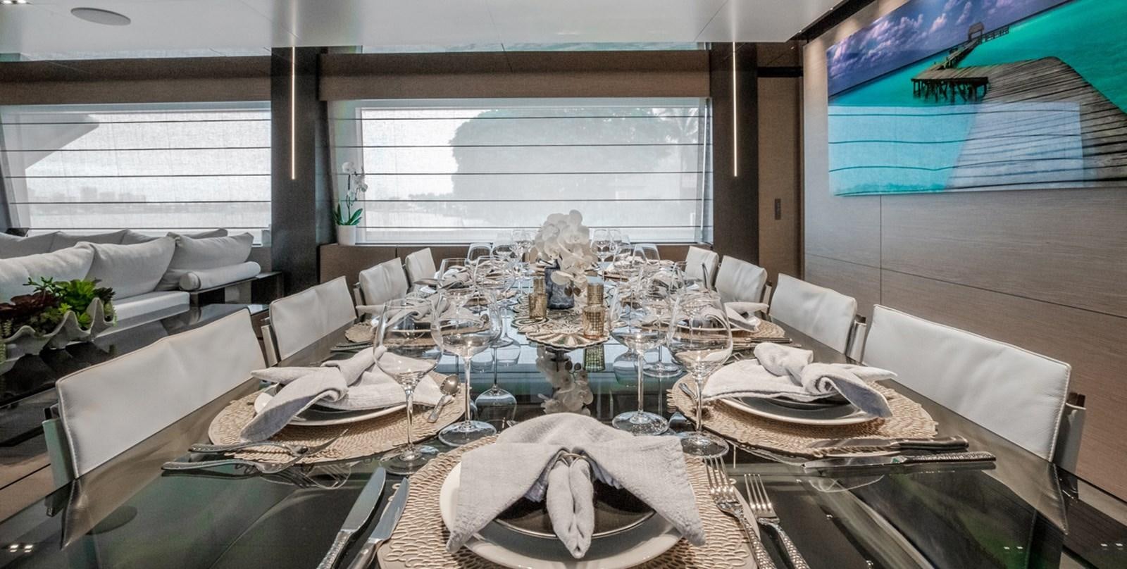 a room with a table and chairs aboard OCEAN Z Yacht for Sale