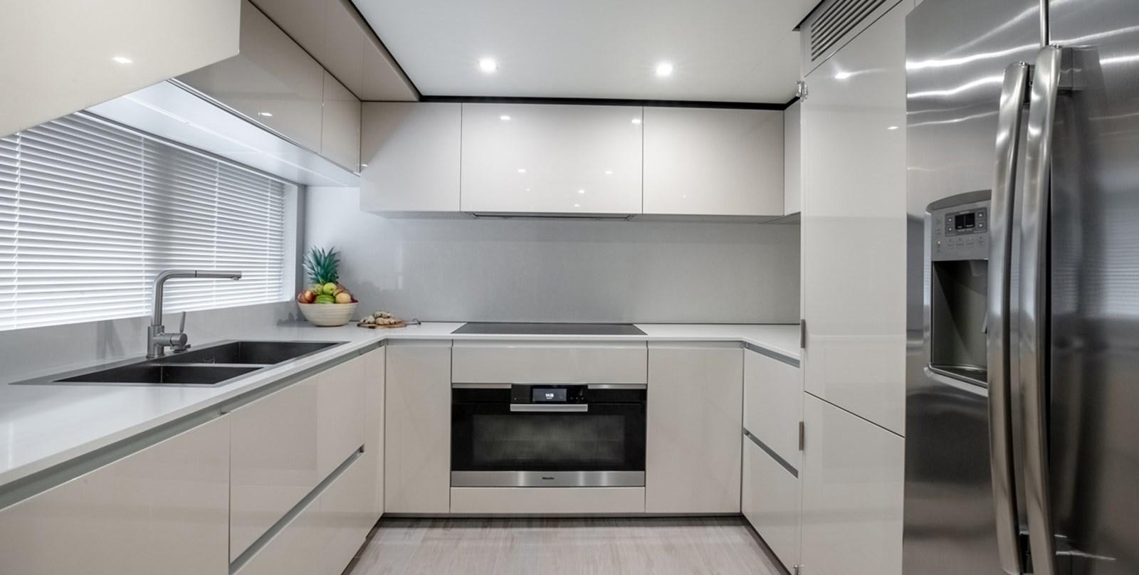 a kitchen with white cabinets aboard OCEAN Z Yacht for Sale