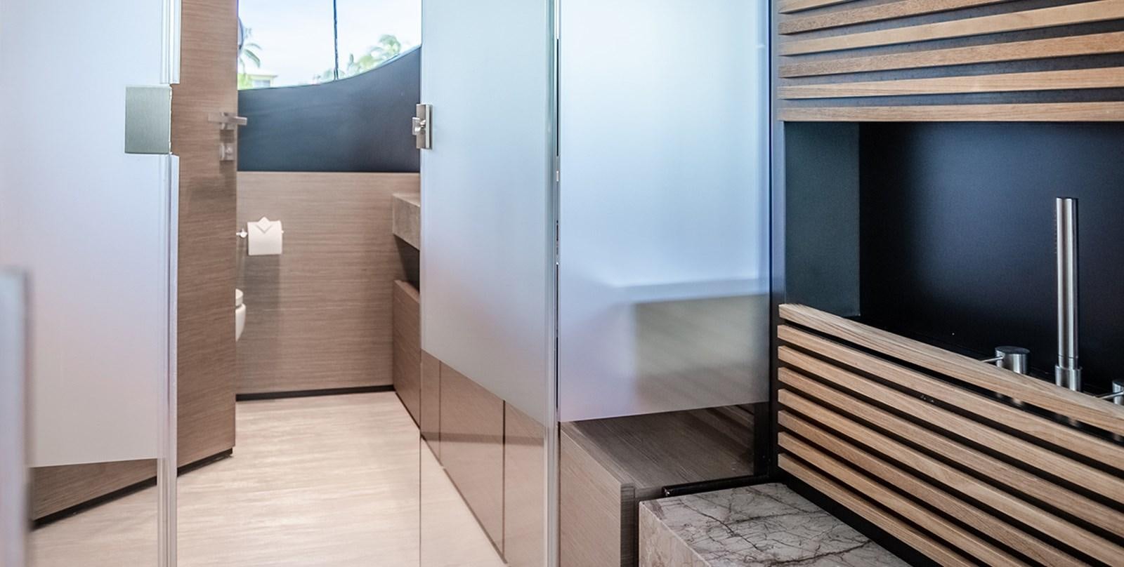 a room with a wood floor and a metal railing aboard OCEAN Z Yacht for Sale