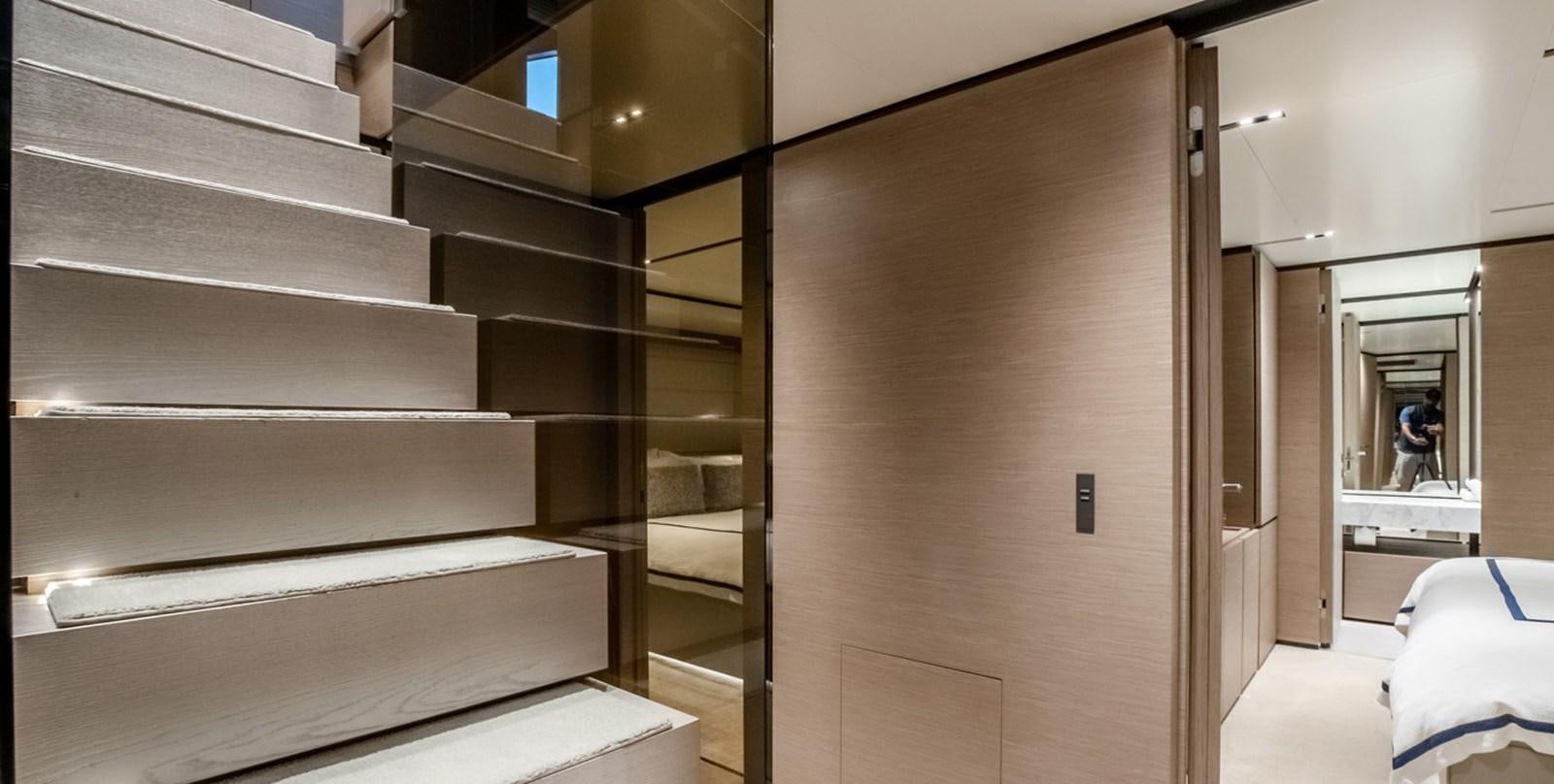 a room with a large wooden staircase aboard OCEAN Z Yacht for Sale