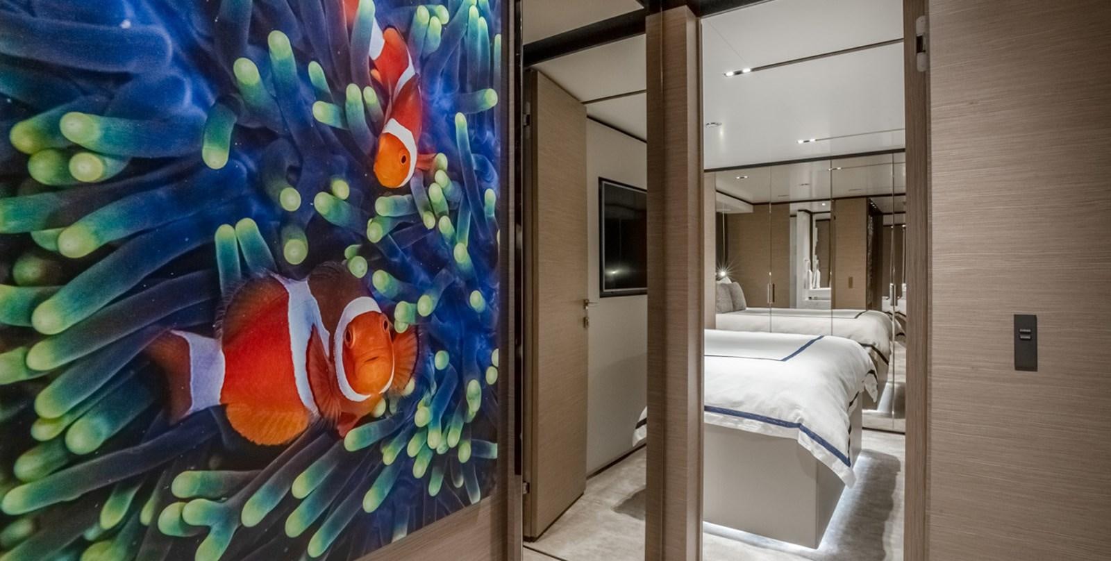 a room with a blue wall with a painting on it aboard OCEAN Z Yacht for Sale