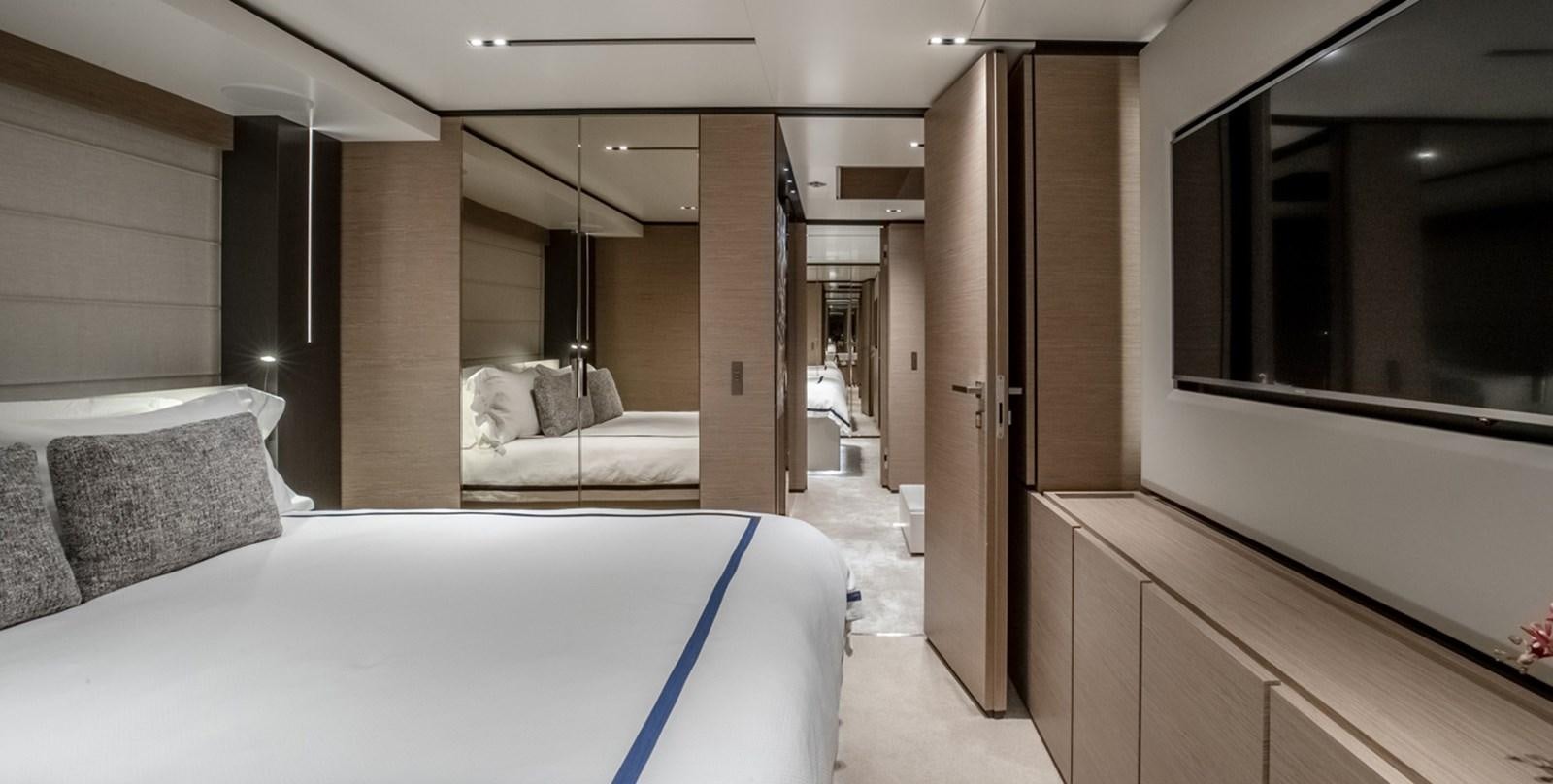 a room with a bed and a mirror aboard OCEAN Z Yacht for Sale