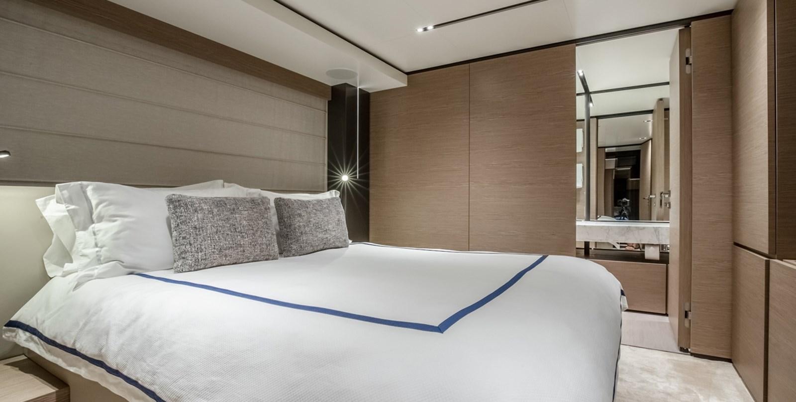 a bed with white sheets aboard OCEAN Z Yacht for Sale