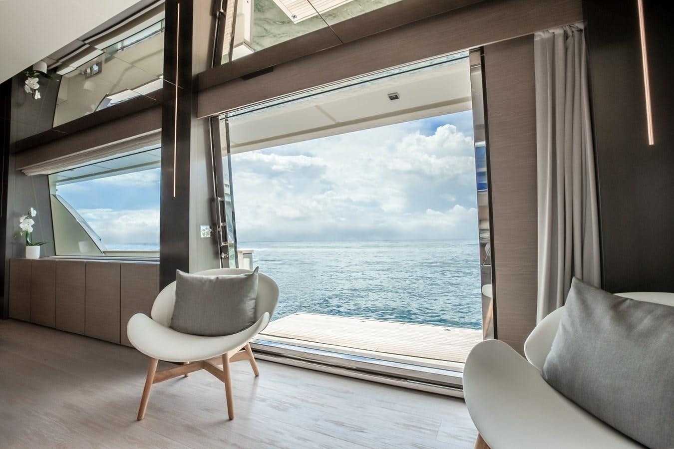 a room with a chair and a large window aboard OCEAN Z Yacht for Sale