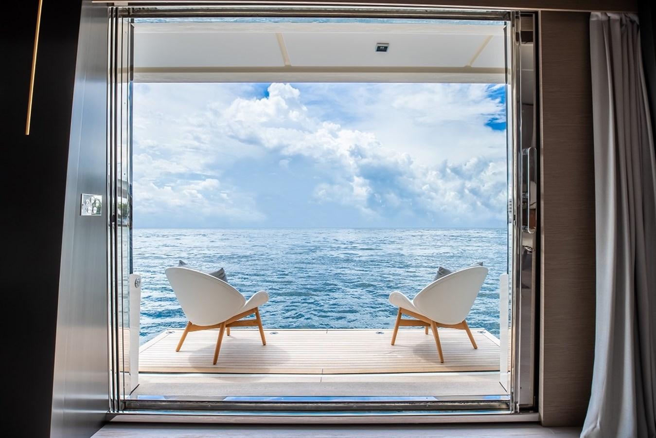 a couple of chairs on a balcony overlooking the ocean aboard OCEAN Z Yacht for Sale