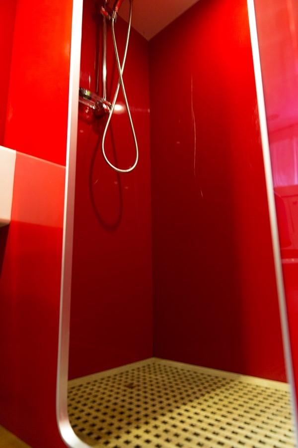 a red door with a metal handle aboard ENIGMA BLUE Yacht for Sale