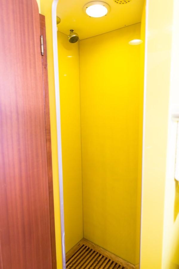 a yellow door with a red curtain aboard ENIGMA BLUE Yacht for Sale