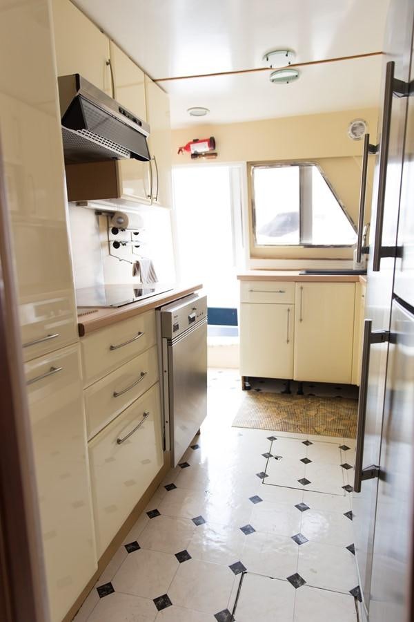 a kitchen with white tiles aboard ENIGMA BLUE Yacht for Sale