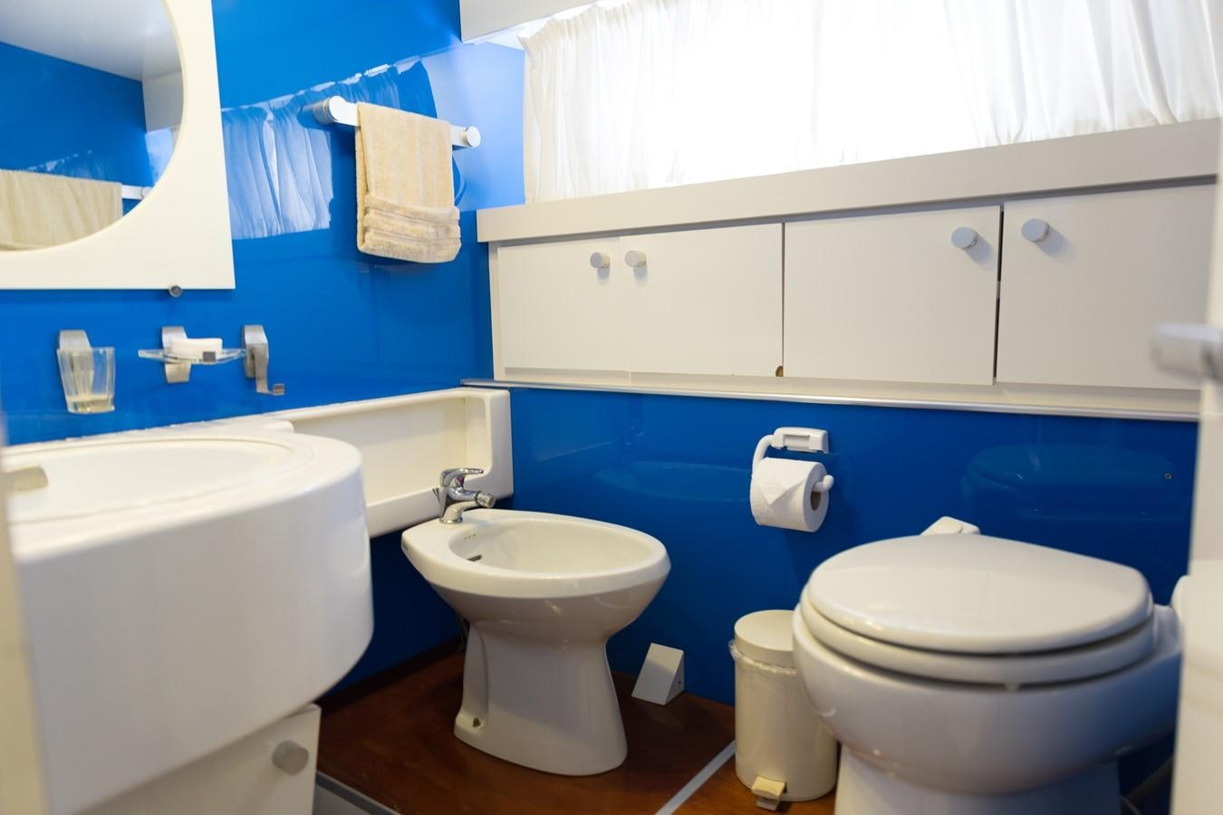 a bathroom with a toilet and a sink aboard ENIGMA BLUE Yacht for Sale