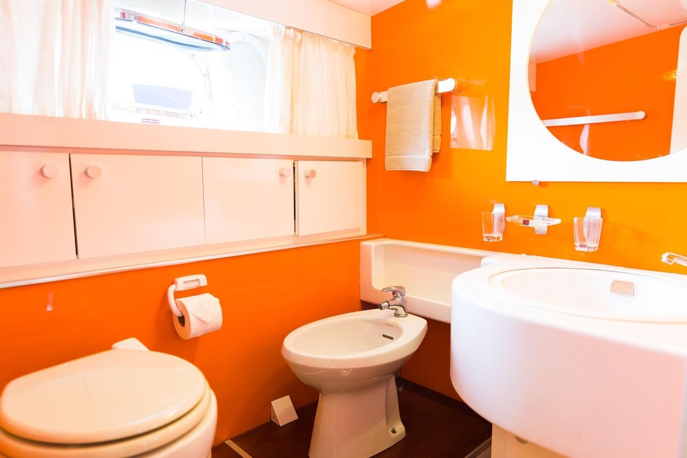 a bathroom with orange walls aboard ENIGMA BLUE Yacht for Sale