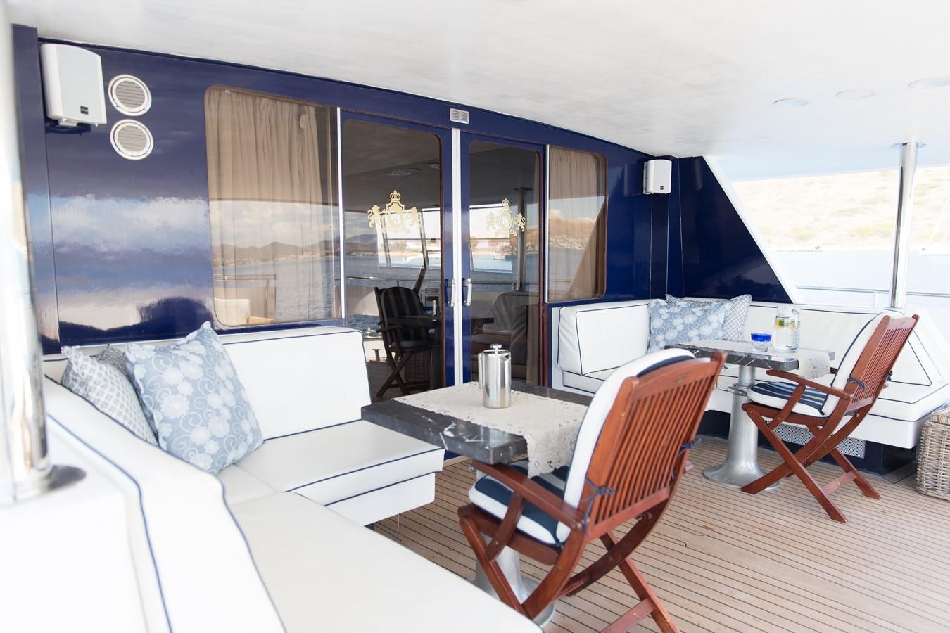 a room with a couch and a table and chairs aboard ENIGMA BLUE Yacht for Sale