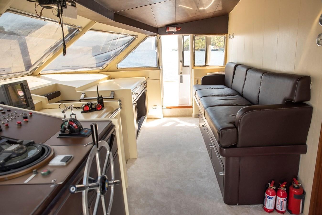 a room with a couch and a desk aboard ENIGMA BLUE Yacht for Sale