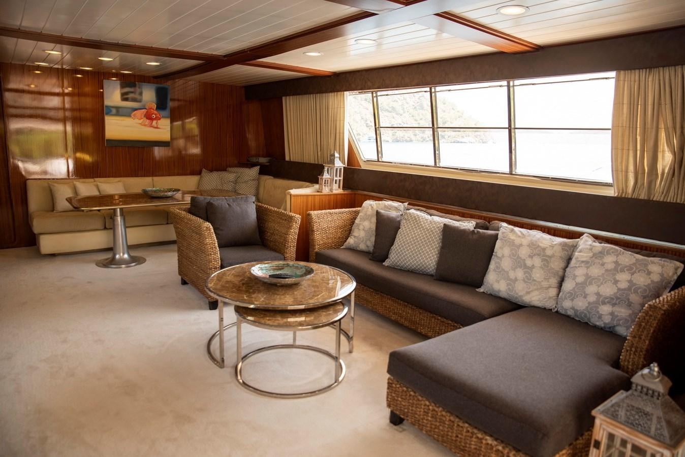 a living room with couches and a coffee table aboard ENIGMA BLUE Yacht for Sale