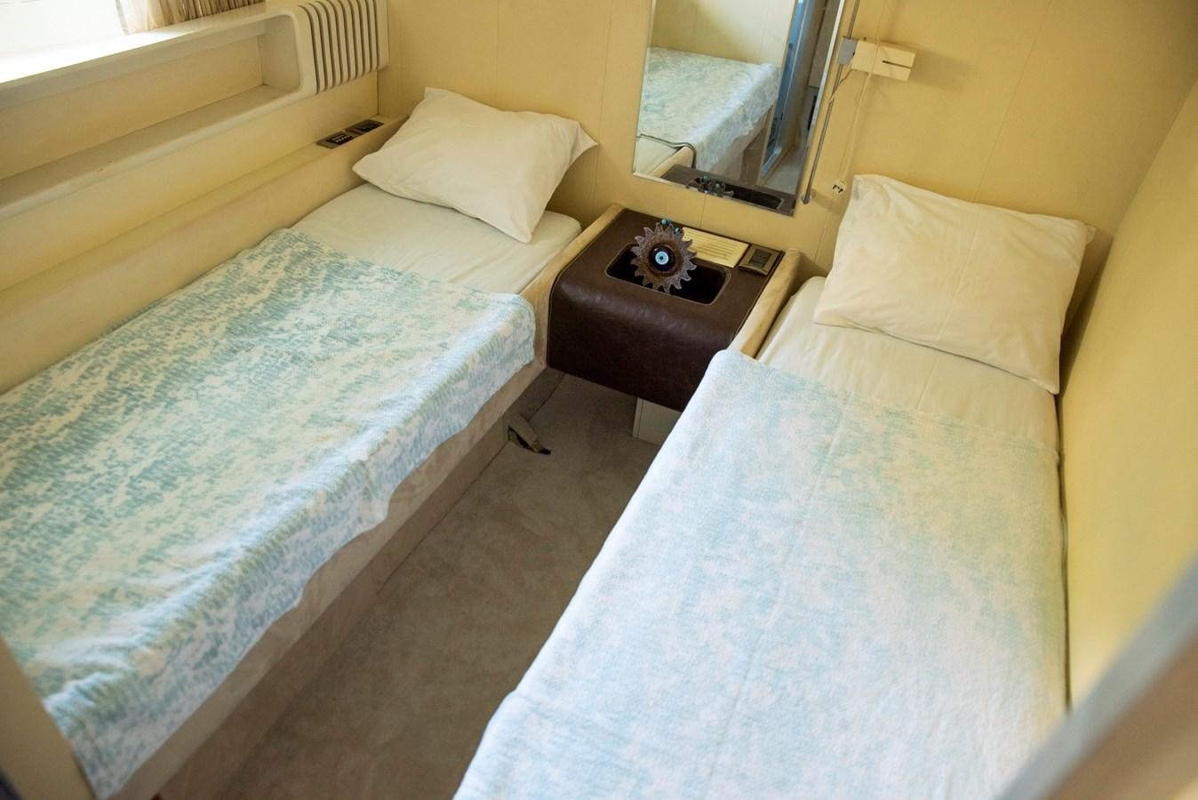 a hotel room with two beds aboard ENIGMA BLUE Yacht for Sale