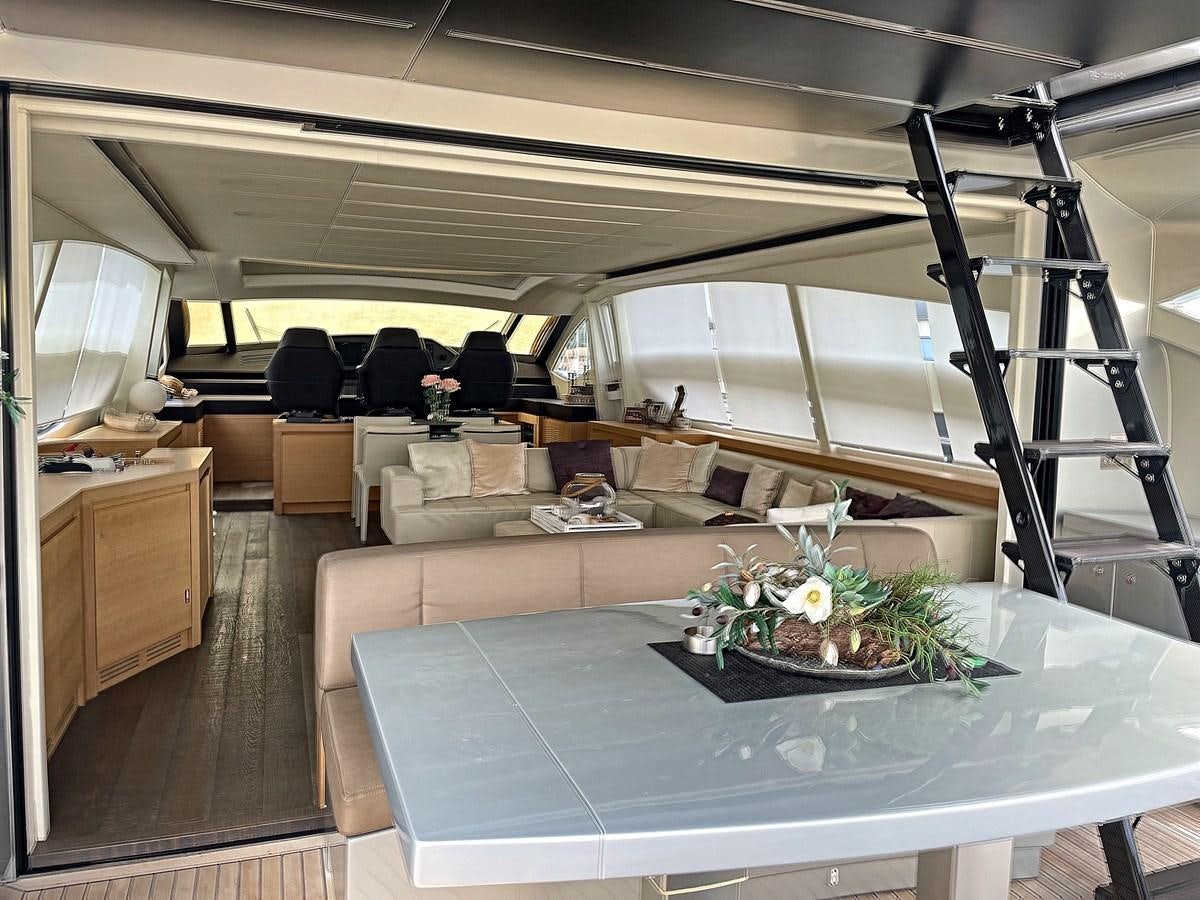 a room with a table and chairs aboard X-TREM I Yacht for Sale