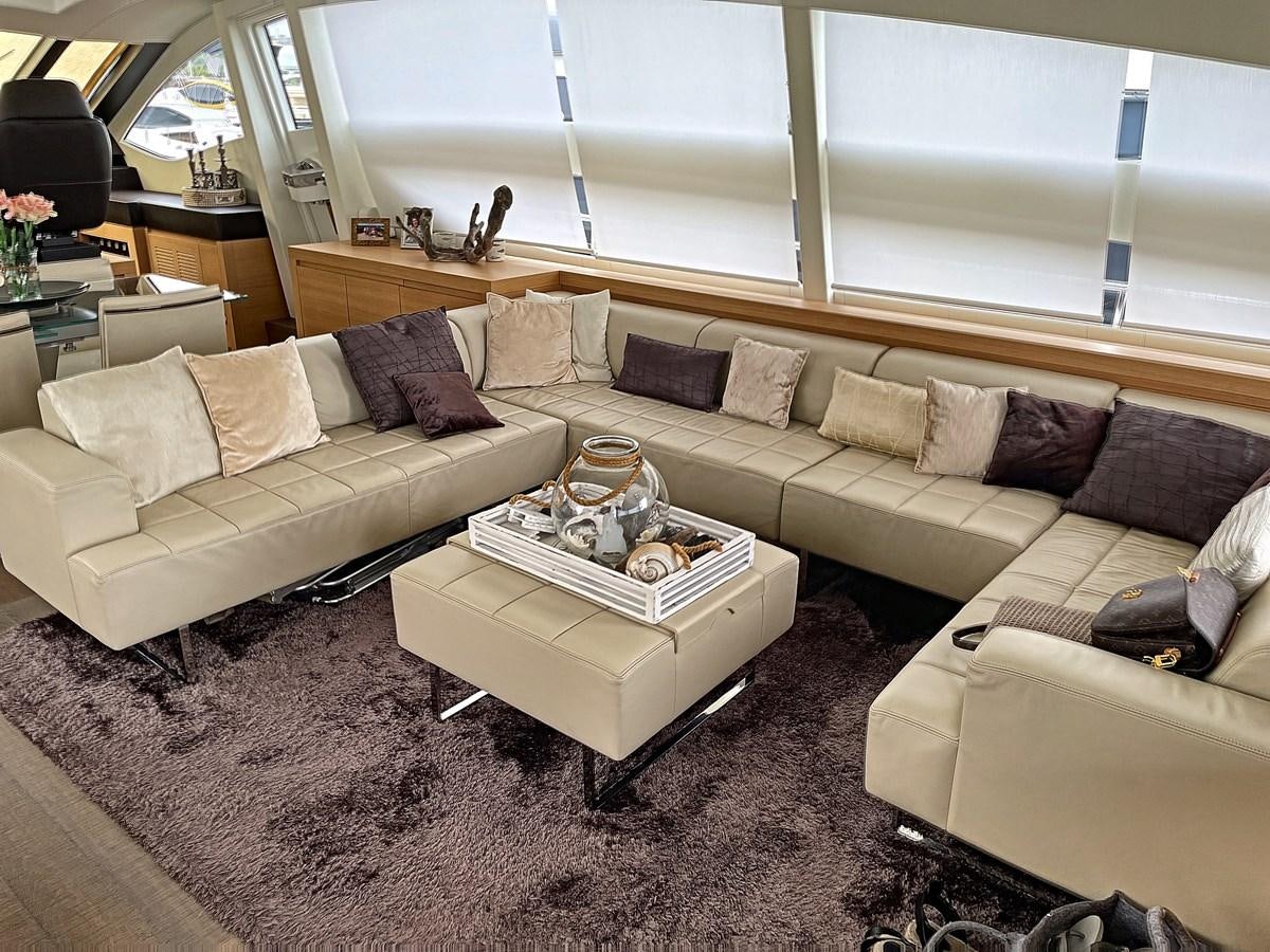 a living room with a couch and a coffee table aboard X-TREM I Yacht for Sale