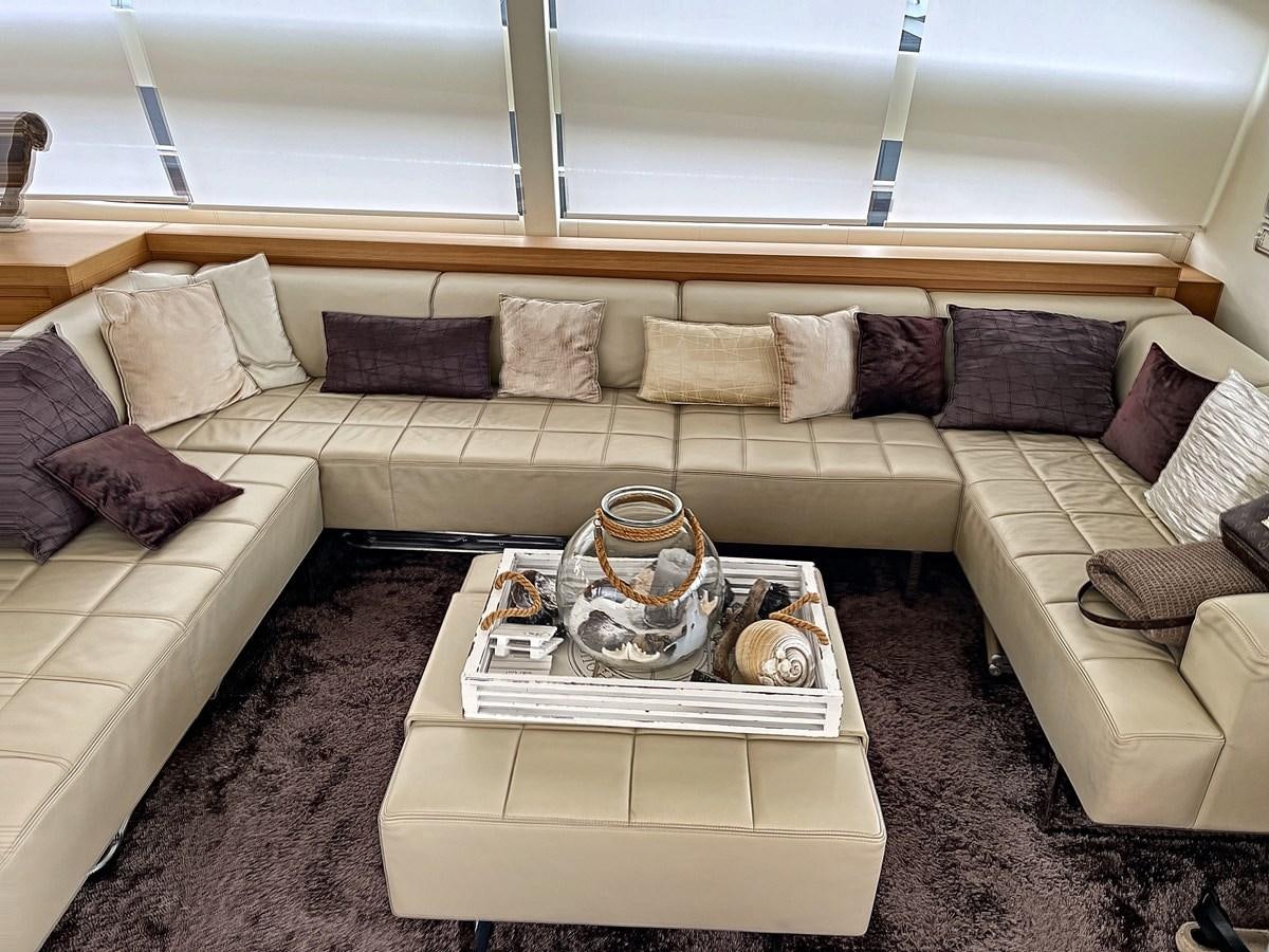 a couch with a coffee table aboard X-TREM I Yacht for Sale