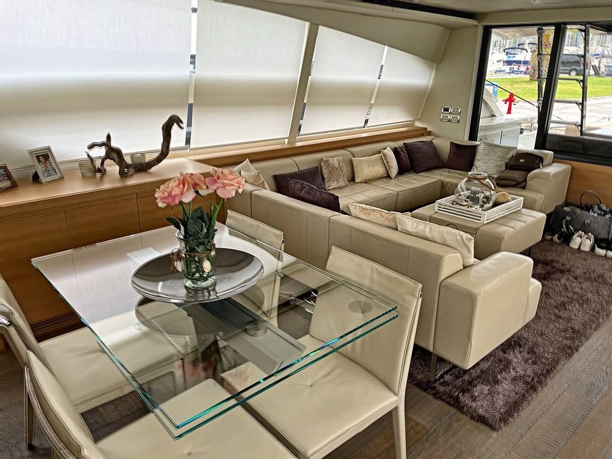 a living room with a glass coffee table and a couch aboard X-TREM I Yacht for Sale