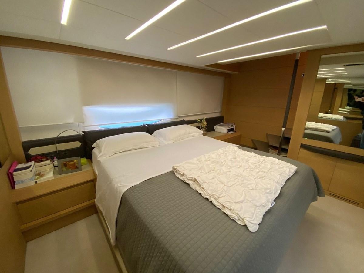 a room with a bed and a desk aboard X-TREM I Yacht for Sale