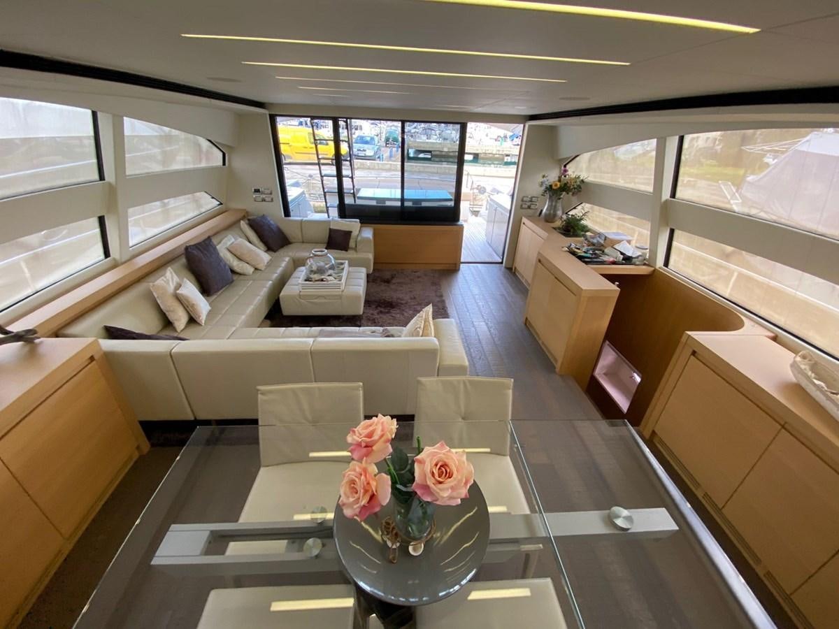 a living room with a vase of flowers on a table aboard X-TREM I Yacht for Sale