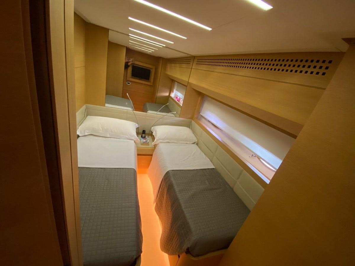 a room with a bed and a television aboard X-TREM I Yacht for Sale